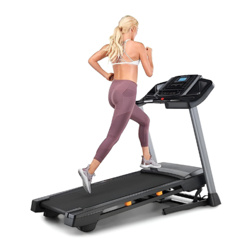 A woman running or completing a workout on a NordicTrack Treadmill, exercising to get fit.